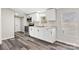 Close up of renovated kitchen with stainless steel appliances, white cabinets and wood grain flooring at 8670 Carroll St, Hickory, NC 28601