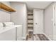 Laundry room with washer and dryer hookups and wood storage shelving at 8670 Carroll St, Hickory, NC 28601