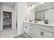 Elegant bathroom featuring double vanity, quartz countertops, modern fixtures, walk-in shower, and a spacious walk-in closet at 9096 El Sworth Dr, Sherrills Ford, NC 28673