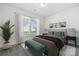 Comfortable bedroom featuring neutral decor, a cozy bed, a large window, and stylish furnishings at 9096 El Sworth Dr, Sherrills Ford, NC 28673