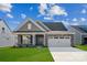 Charming single-story home featuring stone accents, a two-car garage, and a well-maintained lawn at 9096 El Sworth Dr, Sherrills Ford, NC 28673