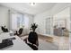 Well-lit home office with modern desks, stylish chairs, neutral walls, and a large window providing natural light at 9096 El Sworth Dr, Sherrills Ford, NC 28673