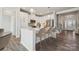 Bright kitchen featuring white cabinets, quartz countertops, stainless steel appliances, and a large island with bar seating at 9096 El Sworth Dr, Sherrills Ford, NC 28673