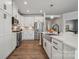 Well-lit kitchen with stainless steel appliances, white cabinets, quartz countertops, and modern fixtures at 9096 El Sworth Dr, Sherrills Ford, NC 28673