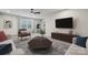 Living room featuring a neutral color scheme, ceiling fan, large windows and comfortable seating at 9096 El Sworth Dr, Sherrills Ford, NC 28673