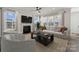Cozy living room with a fireplace, large windows, and comfortable seating at 9096 El Sworth Dr, Sherrills Ford, NC 28673