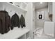 Bright mudroom with white storage cubbies, bench, coat hooks, and laundry room access at 9096 El Sworth Dr, Sherrills Ford, NC 28673