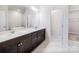 Bright bathroom featuring double vanity, large mirror, and access to the closet and bathtub at 9528 Pointer Rd # 63, Huntersville, NC 28078