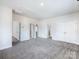 Spacious carpeted bedroom with modern doors, neutral paint, and ample natural light at 9528 Pointer Rd # 63, Huntersville, NC 28078