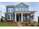 Charming two-story home with blue siding, stone accents, covered porch and manicured front lawn at 9528 Pointer Rd # 63, Huntersville, NC 28078