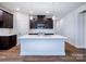 Modern kitchen with white countertops, stainless steel appliances, dark wood cabinets, and island at 9528 Pointer Rd # 63, Huntersville, NC 28078