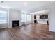 Spacious living room featuring wood floors, fireplace, and open-concept design with kitchen view at 9528 Pointer Rd # 63, Huntersville, NC 28078