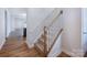 Carpeted staircase with white risers and wood handrail in a bright, modern home interior at 9528 Pointer Rd # 63, Huntersville, NC 28078