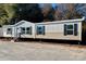 Exterior view of a charming mobile home with symmetrical design, dark shutters, and a welcoming entryway at 00 Old York Rd, Chester, SC 29706