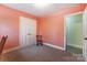 Cozy bedroom with closet, chair and peach colored walls at 10031 Bora Bora Dr, Tega Cay, SC 29708