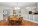 Bright dining room featuring hardwood floors and a view into the cozy living room at 10031 Bora Bora Dr, Tega Cay, SC 29708