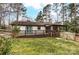 Exterior view showcasing the wooden deck, screened porch, and a fenced backyard at 10031 Bora Bora Dr, Tega Cay, SC 29708