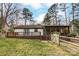 Charming home featuring a wooden deck, screened porch, and a fenced backyard at 10031 Bora Bora Dr, Tega Cay, SC 29708