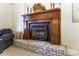 Close-up of a charming brick fireplace with a rustic wooden mantle and decorative accents at 10031 Bora Bora Dr, Tega Cay, SC 29708