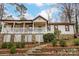 Charming home featuring a stone foundation, brick stairs, and a cozy covered porch with white railings at 10031 Bora Bora Dr, Tega Cay, SC 29708