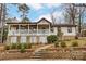 Charming home featuring a stone foundation, brick stairs, and a cozy covered porch with white railings at 10031 Bora Bora Dr, Tega Cay, SC 29708