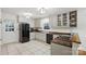 Well-lit kitchen showcases white cabinets, modern appliances, and neutral tile flooring at 10031 Bora Bora Dr, Tega Cay, SC 29708
