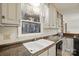 Bright kitchen featuring a stainless steel sink with double basin, neutral countertops, and ample natural light at 10031 Bora Bora Dr, Tega Cay, SC 29708
