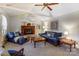 Cozy living room with vaulted ceilings, a brick fireplace, and comfortable blue furniture at 10031 Bora Bora Dr, Tega Cay, SC 29708
