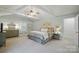 Large main bedroom with high ceilings, ensuite bathroom, and bright natural light at 10031 Bora Bora Dr, Tega Cay, SC 29708
