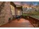 View of the wood back deck with a dining set and a view of the brick home at 1017 Patrick Johnston Ln, Davidson, NC 28036