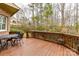 View of the wood back deck with a dining set and a view of the wooded backyard at 1017 Patrick Johnston Ln, Davidson, NC 28036