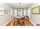 Bright breakfast nook with plantation shutters, hardwood floors, and stylish chandelier at 1017 Patrick Johnston Ln, Davidson, NC 28036