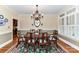Formal dining room featuring a large table, elegant chandelier, and classic architectural details at 1017 Patrick Johnston Ln, Davidson, NC 28036