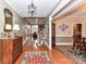 Elegant foyer with hardwood floors, coffered ceiling, and an open view of the staircase and formal dining area at 1017 Patrick Johnston Ln, Davidson, NC 28036
