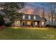 Inviting brick home with a well-manicured lawn and covered front porch perfect for relaxing evenings at 1017 Patrick Johnston Ln, Davidson, NC 28036