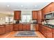 Well-appointed kitchen with stainless steel appliances, granite countertops, and custom wood cabinetry at 1017 Patrick Johnston Ln, Davidson, NC 28036