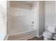 Bright bathroom showcasing a tub with shower and white toilet at 1066 Streamlet Way, Monroe, NC 28110