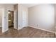 Spacious bedroom featuring wood-look floors, closet, and easy access to the bathroom at 1066 Streamlet Way, Monroe, NC 28110