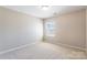 Bedroom features a bright window, neutral paint and carpet at 1066 Streamlet Way, Monroe, NC 28110