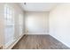 Bright and airy empty room featuring light grey walls, wood-look flooring, and lots of natural light at 1066 Streamlet Way, Monroe, NC 28110