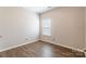 Bright, cozy bedroom featuring wood-look floors and a window at 1066 Streamlet Way, Monroe, NC 28110