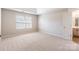 Bright bedroom features neutral carpet, tray ceiling, and light-filled window at 1066 Streamlet Way, Monroe, NC 28110