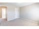 Bright bedroom with open door leading to hall at 1066 Streamlet Way, Monroe, NC 28110