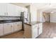Open kitchen featuring white cabinets, stainless steel appliances, and center island at 1066 Streamlet Way, Monroe, NC 28110