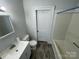 Well-lit bathroom featuring a white sink vanity, toilet, and shower-tub combination at 110 2Nd St, Spencer, NC 28159