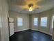 Charming bedroom featuring hardwood floors, three windows, and a ceiling fan at 110 2Nd St, Spencer, NC 28159
