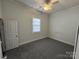 Bedroom with ceiling fan, window, painted wood paneling, and neutral-colored carpeting at 110 2Nd St, Spencer, NC 28159