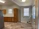 Eat-in kitchen featuring tile floors, wooden cabinets, ample counter space, and updated appliances at 110 2Nd St, Spencer, NC 28159
