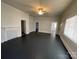 A spacious living room with dark wood floors, a fireplace, and natural light streaming through the windows at 110 2Nd St, Spencer, NC 28159