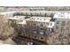 Aerial view of the apartment building, featuring brick facade, balconies, and windows, nestled among trees at 1101 W 1St St # 124, Charlotte, NC 28202